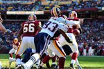 LANDOVER, MD - DECEMBER 11:  Rex Grossman #8 of the Washington Redskins fumbles as he is hit by Andre Carter #93 of the New England Patriots at FedEx Field on December 11, 2011 in Landover, Maryland. (Photo by Scott Cunningham/Getty Images)