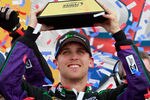 KANSAS CITY, KS - APRIL 22:  Denny Hamlin, driver of the #11 FedEx Ground Toyota, celebrates with the trophy in victory lane after he won the NASCAR Sprint Cup Series STP 400 at Kansas Speedway on April 22, 2012 in Kansas City, Kansas.  (Photo by Chris Graythen/Getty Images for NASCAR)
