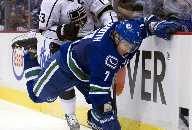 VANCOUVER, CANADA - APRIL 13: Dustin Brown #23 of the Los Angeles Kings knocks down David Booth #7 of the Vancouver Canucks behind the net during the second period in Game Two of the Western Conference Quarterfinals during the 2012 NHL Stanley Cup Playoffs at Rogers Arena on April 13, 2012 in Vancouver, British Columbia, Canada.  (Photo by Rich Lam/Getty Images)