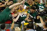 GREEN BAY, WI - AUGUST 19: Alex Green #20 of the Green Bay Packers celebrates a touchdown with a Lambeau leap in the stands against the Arizona Cardinals in a preseason game at Lambeau Field on August 19, 2011 in Green Bay, Wisconsin. (Photo by Scott Boehm/Getty Images)