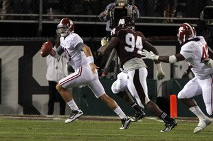 STARKVILLE, MS - NOVEMBER 12:  quarterback AJ McCarron #10 of the Alabama Crimson Tide scrambles away from pressure from defensive lineman Fletcher Cox #94 of the Mississippi State Bulldogs on November 12, 2011 at Davis Wade Stadium in Starkville, Mississippi. Alabama won 24-7. (Photo by Butch Dill/Getty Images)