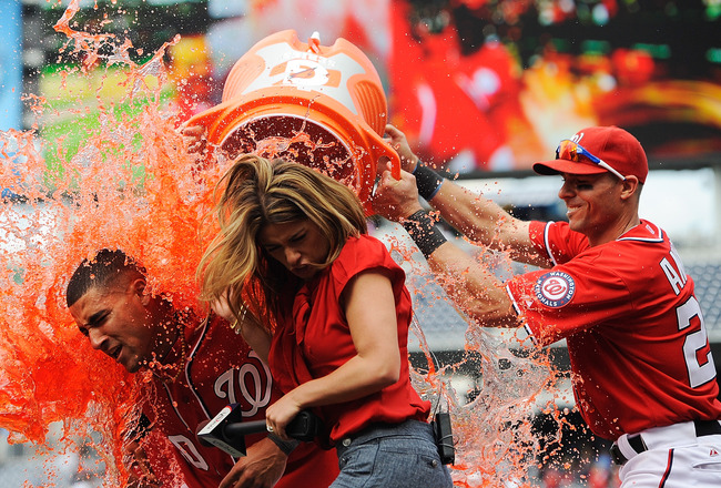 WASHINGTON, DC - APRIL 21:  :  Ian Desmond #20 of the Washington Nationals is doused with Gatorade by his teammates after hitting the game winning sacrifice fly to center in the bottom of the tenth inning against the Miami Marlins at Nationals Park on April 21, 2012 in Washington, DC.  (Photo by Patrick McDermott/Getty Images)