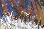 DALLAS, TX - JUNE 16: Guard Jason Kidd of the Dallas Mavericks hoists the Larry O'Brien Trophy from the American Airlines Center balcony for fans gathered at Victory Plaza during the Dallas Mavericks Victory celebration on June 16, 2011 in Dallas, Texas. (Photo by Brandon Wade/Getty Images)