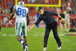 TAMPA, FL - DECEMBER 17:  Coach Jason Garrett applauds wide receiver Dez Bryant #88 of the Dallas Cowboys before play against the Tampa Bay Buccaneers December 17, 2011 at Raymond James Stadium in Tampa, Florida. (Photo by Al Messerschmidt/Getty Images)
