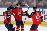 SUNRISE, FL - MARCH 13: Sean Bergenheim #20 is congratulated by Tomas Kopecky #82 and Marcel Goc #57 of the Florida Panthers after scoring his second goal of the game against the Toronto Maple Leafs on March 13, 2012 at the BankAtlantic Center in Sunrise, Florida. The Panthers defeated the Maple Leafs 5-2. (Photo by Joel Auerbach/Getty Images)