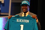 NEW YORK, NY - APRIL 26:  Justin Blackmon from Oklahoma State holds up a jersey as he stands on stage after he was selected #5 overall by the Jacksonville Jaguars in the first round of the 2012 NFL Draft at Radio City Music Hall on April 26, 2012 in New York City.  (Photo by Al Bello/Getty Images)