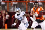 BLACKSBURG, VIRGINIA - NOVEMBER 17:  Quarterback Logan Thomas #3 of the Virginia Tech Hokies prepares to throw the ball as linebacker Zach Brown #47 of the North Carolina Tar Heels chases at Lane Stadium on November 17, 2011 in Blacksburg, Virginia. (Photo by Geoff Burke/Getty Images)