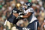 SOUTH BEND, IN - NOVEMBER 21: Guard Eric Olsen #55  of the Notre Dame Fighting Irish blocks Kendall Reyes #99 of the Univeristy of Connecticut Huskies at Notre Dame Stadium on November 21, 2009 in South Bend, Indiana. (Photo by Jonathan Daniel/Getty Images)
