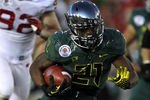 PASADENA, CA - JANUARY 02:  Running back LaMichael James #21 of the Oregon Ducks is tackled by a Wisconsin Badgers defender at the 98th Rose Bowl Game on January 2, 2012 in Pasadena, California.  (Photo by Stephen Dunn/Getty Images)
