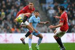 MANCHESTER, ENGLAND - JANUARY 08:  Chris Smalling of Manchester United competes with Sergio Aguero of Manchester City during the FA Cup Third Round match between Manchester City and Manchester United at the Etihad Stadium on January 8, 2012 in Manchester, England.  (Photo by Laurence Griffiths/Getty Images)