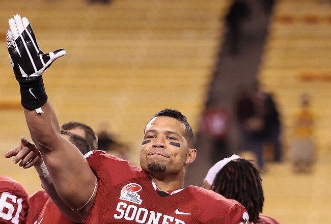TEMPE, AZ - DECEMBER 30:  Linebacker Travis Lewis #28 of the Oklahoma Sooners celebrates following the Insight Bowl against the Iowa Hawkeyes at Sun Devil Stadium on December 30, 2011 in Tempe, Arizona. The Sooners defeated the Hawkeyes 31-14.  (Photo by Christian Petersen/Getty Images)