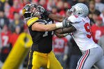 IOWA CITY, IA - NOVEMBER 20:  Quarterback Ricky Stanzi #12 of the University of Iowa Hawkeyes throws under pressure from defensive lineman Solomon Thomas #98 of the Ohio State Buckeyes as offensive lineman Riley Reiff #77 defends during the first half of play at Kinnick Stadium on November 20, 2010 in Iowa City, Iowa. Ohio State won 20-17 over Iowa. (Photo by David Purdy/Getty Images)
