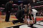 CHICAGO, IL - APRIL 28:  Derrick Rose #1 of the Chicago Bulls is lifted off of the court as coach Tom Thibodeau (L) watches after suffering a knee injury against the Philadelphia 76ers in Game One of the Eastern Conference Quarterfinals during the 2012 NBA Playoffs at the United Center on April 28, 2012 in Chicago, Illinois. The Bulls defeated the 76ers 103-91. NOTE TO USER: User expressly acknowledges and agrees that, by downloading and or using this photograph, User is consenting to the terms and conditions of the Getty Images License Agreement.  (Photo by Jonathan Daniel/Getty Images)