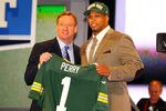 NEW YORK, NY - APRIL 26:  Nick Perry (R) from USC holds up a jersey as he stands on stage with NFL Commissioner Roger Goodell after he was selected #28 overall by the Green Bay Packers in the first round of the 2012 NFL Draft at Radio City Music Hall on April 26, 2012 in New York City.  (Photo by Al Bello/Getty Images)