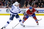 MONTREAL, CANADA - APRIL 4:  Steven Stamkos #91 of the Tampa Bay Lightning shoots the puck in front of Tomas Plekanec #14 of the Montreal Canadiens during the NHL game at the Bell Centre on April 4, 2012 in Montreal, Quebec, Canada.  The Canadiens defeated the Lightning 5-2.  (Photo by Richard Wolowicz/Getty Images)