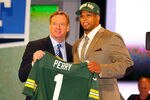 NEW YORK, NY - APRIL 26:  Nick Perry (R) from USC holds up a jersey as he stands on stage with NFL Commissioner Roger Goodell after he was selected #28 overall by the Green Bay Packers in the first round of the 2012 NFL Draft at Radio City Music Hall on April 26, 2012 in New York City.  (Photo by Al Bello/Getty Images)
