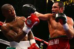 LAS VEGAS - MAY 05:  (R-L) Oscar De La Hoya connects with a right to the face of Floyd Mayweather Jr. during their WBC super welterweight championship fight at the MGM Grand Garden Arena May 5, 2007 in Las Vegas, Nevada.  Mayweather defeated De La Hoya by split decision.  (Photo by Al Bello/Getty Images)