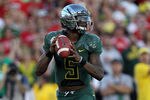 PASADENA, CA - JANUARY 02:  Quarterback Darron Thomas #5 of the Oregon Ducks is looking to pass while taking on the Wisconsin Badgers at the 98th Rose Bowl Game on January 2, 2012 in Pasadena, California.  (Photo by Stephen Dunn/Getty Images)