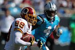CHARLOTTE, NC - OCTOBER 23:  Santana Moss #89 of the Washington Redskins runs past Captain Munnerlyn #41 of the Carolina Panthers during their game at Bank of America Stadium on October 23, 2011 in Charlotte, North Carolina.  (Photo by Scott Halleran/Getty Images)