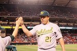 ANAHEIM, CA - APRIL 18: Starting pitcher Bartolo Colon #21 of the Oakland Athletics is greeted as he returns to the dugout after pitchin eight shoutout innings against the Los Angeles Angels of Anaheim at Angel Stadium of Anaheim on April 18, 2012 in Anaheim, California.  Oakland won 6-0.  (Photo by Stephen Dunn/Getty Images)