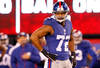 EAST RUTHERFORD, NJ - JANUARY 01:   Osi Umenyiora #72 of the New York Giants looks on against the Dallas Cowboys at MetLife Stadium on January 1, 2012 in East Rutherford, New Jersey.  (Photo by Rich Schultz/Getty Images)