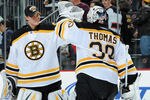 NEWARK, NJ - OCTOBER 16: Tim Thomas #30 of the Boston Bruins is congratulated by Tuukka Rask #40 of the Boston Bruins after the Boston Bruins defeated the New Jersey Devils 4-1 at the Prudential Center on October 16, 2010 in Newark, New Jersey. (Photo by Christopher Pasatieri/Getty Images)