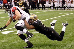 NEW ORLEANS, LA - DECEMBER 26:  Tight end Michael Palmer #81 of the Atlanta Falcons runs after a catch as middle linebacker Jonathan Vilma #51 of the New Orleans Saints dives for the tackle in the third quarter at the Mercedes-Benz Superdome on December 26, 2011 in New Orleans, Louisiana.  (Photo by Chris Graythen/Getty Images)