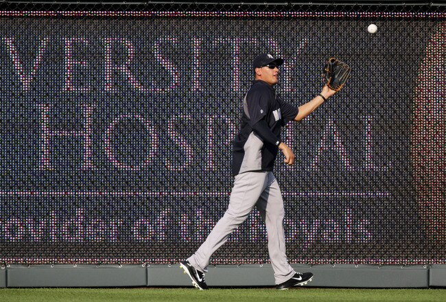 KANSAS CITY, MO - MAY 4:  Freddy Garcia #36 of the New York Yankees catches balls in the outfield during batting practice before a game against the Kansas City Royals at Kauffman Stadium May 4, 2012 in Kansas City, Missouri. (Photo by Ed Zurga/Getty Images)
