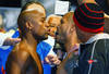LAS VEGAS, NV - MAY 04:  WBA super welterweight champion Miguel Cotto (R) and Floyd Mayweather Jr. face off during the official weigh-in for their bout at the MGM Grand Garden Arena on May 4, 2012 in Las Vegas, Nevada. Cotto will defend his title against Mayweather on May 5, 2012 in Las Vegas.  (Photo by Al Bello/Getty Images)