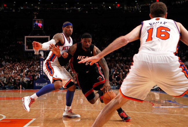 NEW YORK, NY - MAY 03:  LeBron James #6 of the Miami Heat drives against Carmelo Anthony #7 and Steve Novak #16 of the New York Knicks in Game Three of the Eastern Conference Quarterfinals in the 2012 NBA Playoffs on May 3, 2012 at Madison Square Garden in New York City.  NOTE TO USER: User expressly acknowledges and agrees that, by downloading and or using this photograph, User is consenting to the terms and conditions of the Getty Images License Agreement.  (Photo by Jeff Zelevansky/Getty Images)