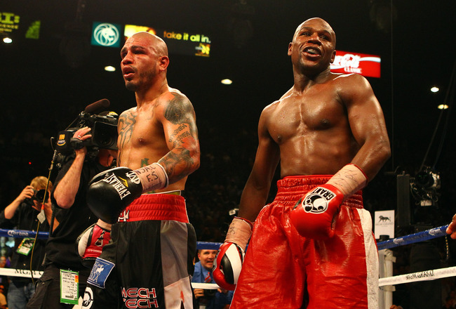 LAS VEGAS, NV - MAY 05:  Miguel Cotto and Floyd Mayweather Jr. react after the end of the 12th round after their WBA super welterweight title fight at the MGM Grand Garden Arena on May 5, 2012 in Las Vegas, Nevada. Mayweather Jr. defeated Cotto by unanimous decision. (Photo by Al Bello/Getty Images)