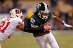 INDIANAPOLIS, IN - DECEMBER 03:  Keshawn Martin #82 of the Michigan State Spartans runs for yards after the catch against Peniel Jean #21 of the Wisconsin Badgers during the Big 10 Conference Championship Game at Lucas Oil Stadium on December 3, 2011 in Indianapolis, Indiana.  (Photo by Gregory Shamus/Getty Images)