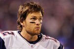EAST RUTHERFORD, NJ - DECEMBER 29:  Tom Brady #12 of the New England Patriots looks on from the sidelines against the New York Giants on December 29, 2007 at Giants Stadium in East Rutherford, New Jersey.  (Photo by Jim McIsaac/Getty Images)