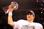 INDIANAPOLIS, IN - FEBRUARY 05:  Quarterback Eli Manning #10 of the New York Giants poses with the Vince Lombardi Trophy after the Giants defeated the Patriots by a score of 21-17 in Super Bowl XLVI at Lucas Oil Stadium on February 5, 2012 in Indianapolis, Indiana.  (Photo by Ezra Shaw/Getty Images)