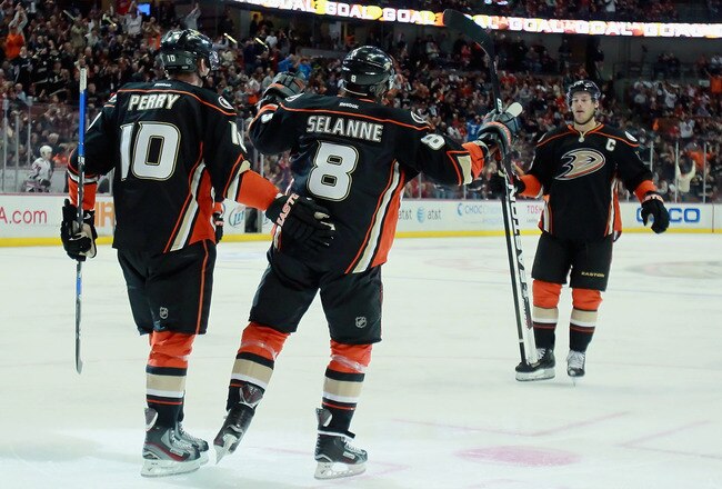 ANAHEIM, CA - FEBRUARY 26:  (L-R) Corey Perry #10, Teemu Selanne #8 and Ryan Getzlaf #15 of the Anaheim Ducks celebrate Selanne's goal in the third period against the Chicago Blackhawks at Honda Center on February 26, 2012 in Anaheim, California.  The Ducks defeated the Blackhawks 3-1.  (Photo by Jeff Gross/Getty Images)