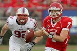 HOUSTON, TX - NOVEMBER 19: Quarterback Case Keenum #7 of the Houston Cougars rushes with the ball while defensive end Margus Hunt #92 of the Southern Methodist University Mustangs gives chase on November 19, 2011 at Robertson Stadium in Houston, Texas. (Photo by Thomas B. Shea/Getty Images)