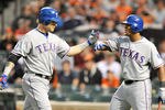 BALTIMORE, MD - MAY 8:  Josh Hamilton #10 of the Texas Rangers celebrates with Adrian Beltre #29 hitting a two-run home run in the third inning during a baseball game against the Baltimore Orioles at Oriole Park at Camden Yards on May 8, 2012 in Baltimore, Maryland.  (Photo by Mitchell Layton/Getty Images)