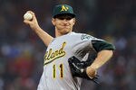 BOSTON, MA - MAY 1:  Jarrod Parker #11 of the Oakland Athletics throws against the Oakland Athletics at Fenway Park May 1, 2012  in Boston, Massachusetts. (Photo by Jim Rogash/Getty Images)