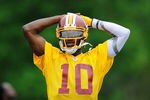 ASHBURN, VA - MAY 06:  Robert Griffin III #10 of the Washington Redskins practices during the Washington Redskins rookie minicamp on May 6, 2012 in Ashburn, Virginia.  (Photo by Patrick McDermott/Getty Images)