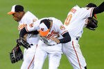 BALTIMORE, MD - APRIL 24:  Endy Chavez #9, Nick Markakis #21 and Adam Jones #10 of the Baltimore Orioles celebrate a win after a baseball game against the Toronto Blue Jays at Oriole Park at Camden Yards on April 24, 2012 in Baltimore, Maryland.  The Orioles won 2-1.  (Photo by Mitchell Layton/Getty Images)