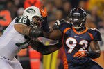 DENVER, CO - NOVEMBER 17:  Defensive lineman Elvis Dumervil #92 of the Denver Broncos fights against the block of offensive tackle Wayne Hunter #78 of the New York Jets at Sports Authority Field at Mile High on November 17, 2011 in Denver, Colorado. The Broncos defeated the Jets 17-13.  (Photo by Doug Pensinger/Getty Images)