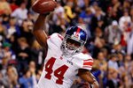 INDIANAPOLIS, IN - FEBRUARY 05:  Fullback Ahmad Bradshaw #44 of the New York Giants celebrates his six-yard touchdown run in the fourth quarter against the New England Patriots during Super Bowl XLVI at Lucas Oil Stadium on February 5, 2012 in Indianapolis, Indiana.  (Photo by Rob Carr/Getty Images)