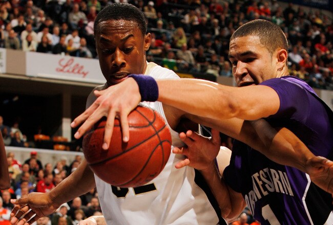 INDIANAPOLIS - MARCH 12:  Forward Drew Crawford #1 of the Northwestern Wildcats trys to keep the ball in bounds against guard John Hart #32 of the Purdue Boilermakers during their quarterfinal game in the Big Ten Men's Basketball Tournament at Conseco Fieldhouse on March 12, 2010 in Indianapolis, Indiana.  (Photo by Jonathan Daniel/Getty Images)