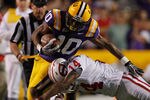 BATON ROUGE, LA - NOVEMBER 12:  Russell Shepard #10 of the Louisiana State University Tigers is tackled by Kareem Peterson #14 of the Western Kentucky Hilltoppers at Tiger Stadium on November 12, 2011 in Baton Rouge, Louisiana.  (Photo by Chris Graythen/Getty Images)