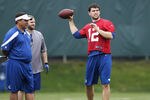 INDIANAPOLIS, IN - MAY 4: Andrew Luck #12 of the Indianapolis Colts works out as quarterbacks coach Clyde Christensen looks on during a rookie minicamp at the team facility on May 4, 2012 in Indianapolis, Indiana. (Photo by Joe Robbins/Getty Images)