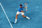 MADRID, SPAIN - MAY 10:  Roger Federer of Switzerland plays a backhand to Richard Gasquet of France during the Mutua Madrilena Madrid Open tennis tournament at the Caja Magica on May 10, 2012 in Madrid, Spain.  (Photo by Jasper Juinen/Getty Images)