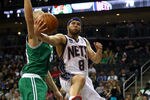 NEWARK, NJ - APRIL 14:  Deron Williams #8 of the New Jersey Nets drives for a shot attempt in the second half against Greg Stiemsma #54 of the Boston Celtics at Prudential Center on April 14, 2012 in Newark, New Jersey. NOTE TO USER: User expressly acknowledges and agrees that, by downloading and or using this photograph, User is consenting to the terms and conditions of the Getty Images License Agreement.  (Photo by Chris Chambers/Getty Images)
