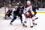 LOS ANGELES, CA - JANUARY 05:  Shane Doan #19 of the Phoenix Coyotes controls the puck as he is checked by Jarret Stoll #28 of the Los Angeles Kings during the first period at Staples Center on January 5, 2012 in Los Angeles, California.  (Photo by Harry How/Getty Images)