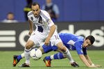 MONTREAL, CANADA - MAY 12:  Landon Donovan #10 of the Los Angeles Galaxy takes the ball from Felipe Martins #7 of the Montreal Impact during the MLS match at the Olympic Stadium on May 12, 2012 in Montreal, Quebec, Canada.  The game ended in a 1-1 tie.  (Photo by Richard Wolowicz/Getty Images)