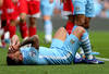 MANCHESTER, ENGLAND - MAY 13:  Carlos Tevez of Manchester City lies on the pitch after being fouled by Joey Barton of QPR during the Barclays Premier League match between Manchester City and Queens Park Rangers at the Etihad Stadium on May 13, 2012 in Manchester, England.  (Photo by Alex Livesey/Getty Images)